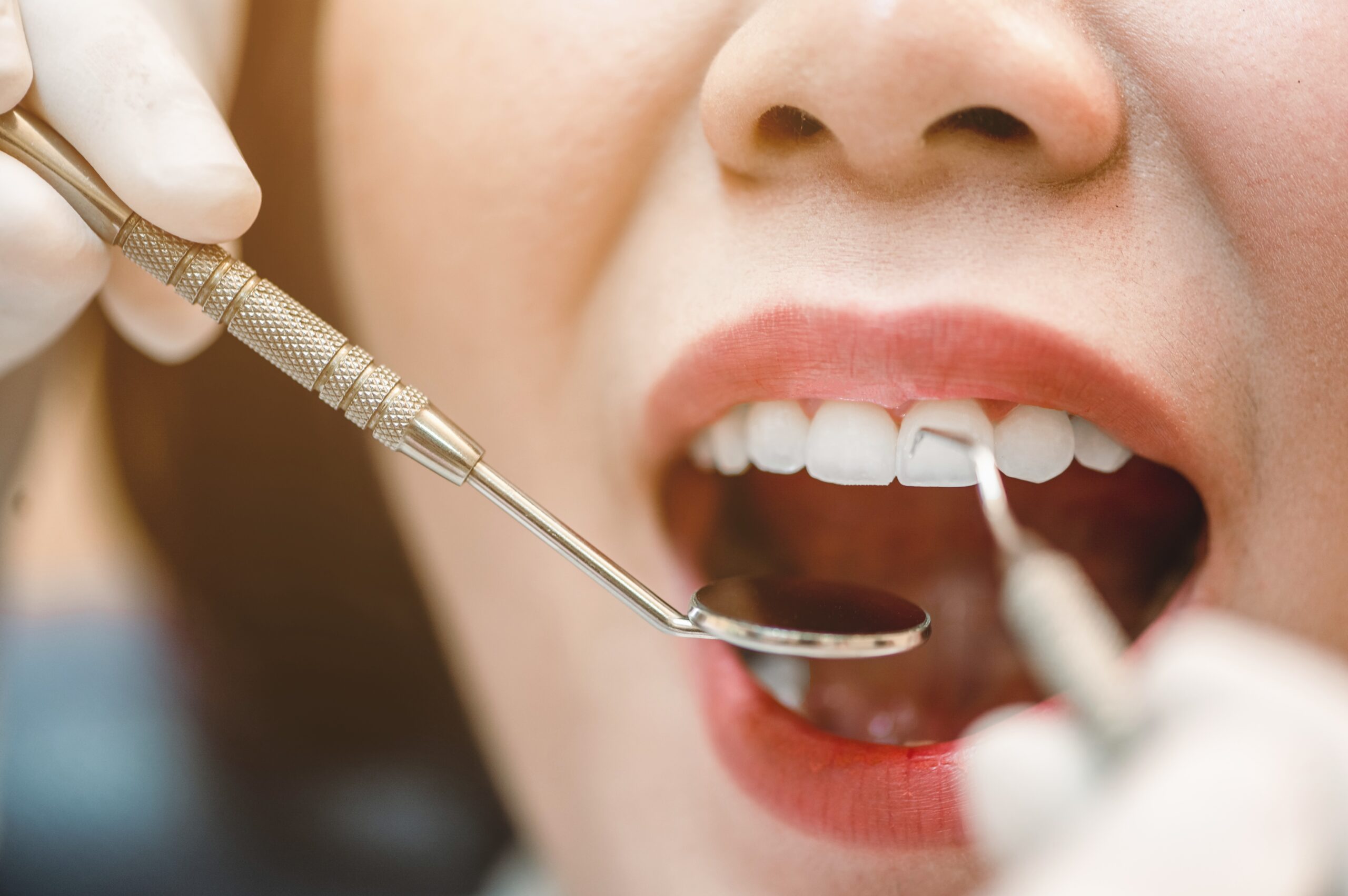 comprehensive-exams Dental professional examining teeth and gums during a comprehensive exam.